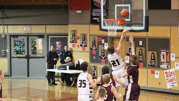 Dakota Prukop completes a drive to the basket against Dripping Springs last Friday night at Lake Travis High School. 