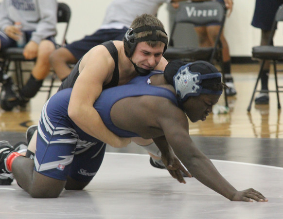 Junior Harrison Holmes goes in for the win against one of his toughest opponents. On Dec. 5 the team went up against Shoemaker and came away with a win. Submitted photo. 