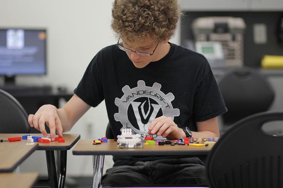 Junior Eddie Bates builds a  personal model with LEGOS at the club.