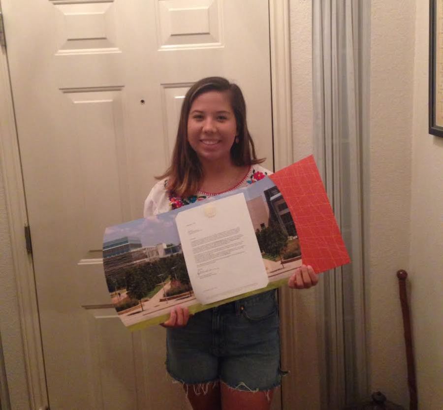 Senior Jill Fry displays her acceptance to the  University of Texas at Dallas. 