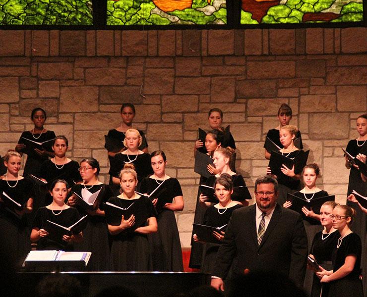 The womens chorale choir prepares for their performance. 