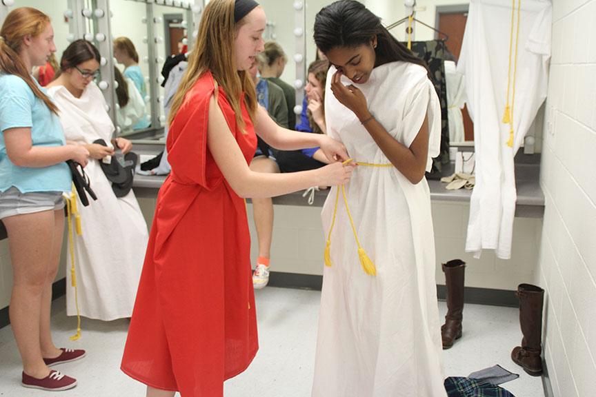 Rachel Frith helps Christina Eure secure her costume before the dress rehearsal of The Greek Mythology Olympiaganza, which opens tonight. 