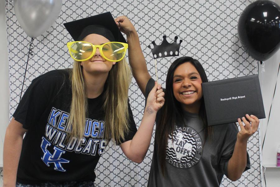 Seniors+Morgan+Waggoner+and+Kriston+Guerra+pose+for+available+photo+booth+at+The+Cookies+for+College+event.