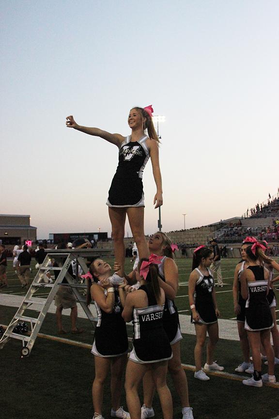 Seniors Brittany Brown and Morgan Threadgill and Sophomores Quinn and Tatum Appel preform a stunt at the game against Vista Ridge. Vista Ridge beat the Vipers 57-52. 