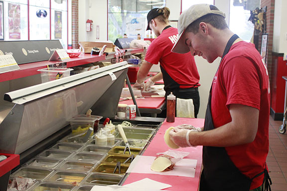 Junior Joseph DAmato builds a sandwich at Firehouse Subs Lakeway.