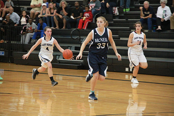 Madison Byrne controls the ball at the top of the court. 