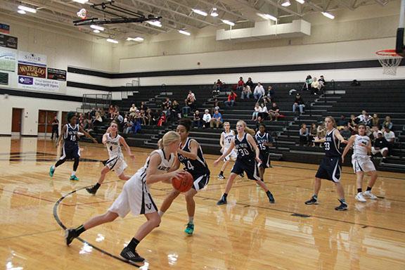 Taylor Byrne drives down the court. 