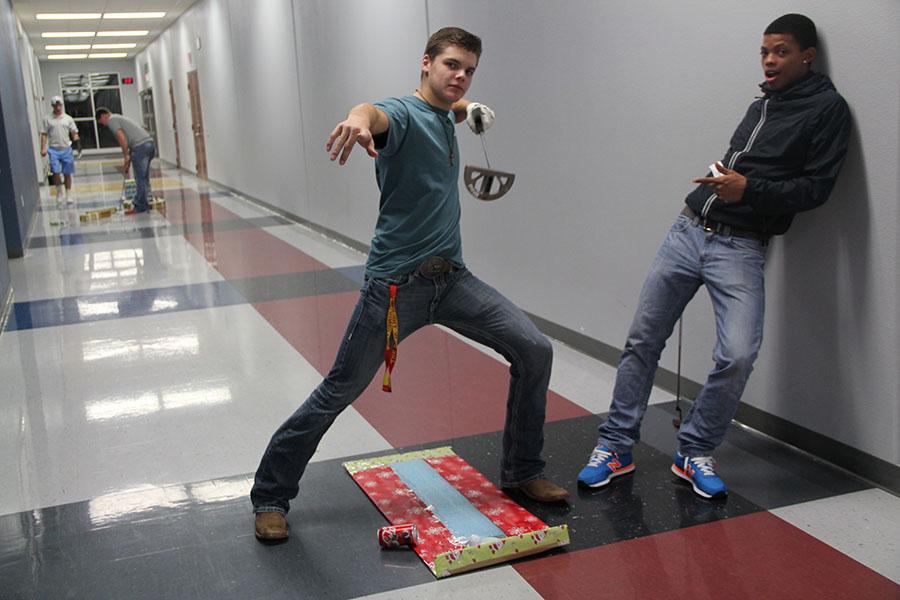 Juniors Garrison Spring 
and Qwevonte Eure 
pose while playing a round of Christmas Mini Golf  during the FCA miniature golf tournament.