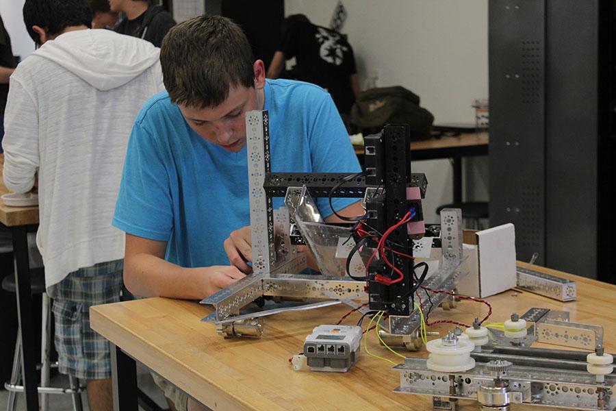 Senior Layton Schleich works on his robotics creation 