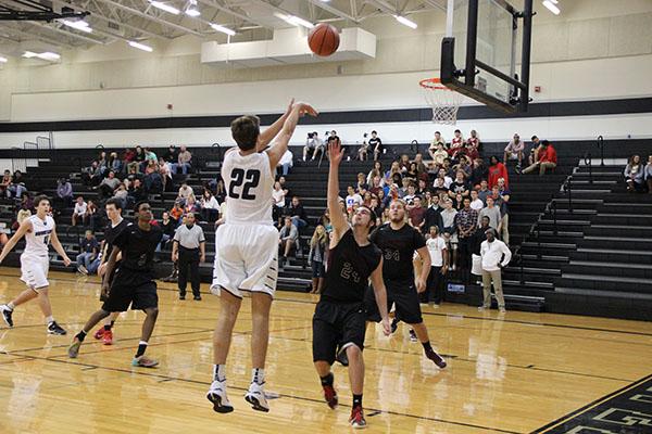 Lucas Williams takes a shot from the bottom right corner of the court. 