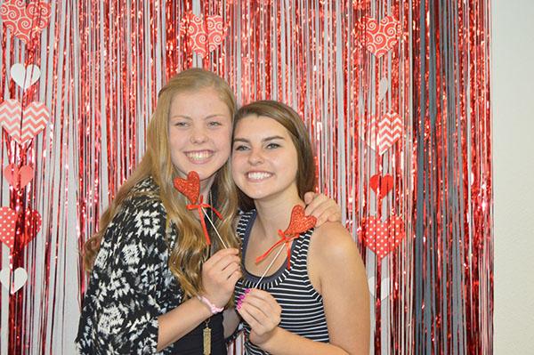 Kendall+Shields+and+Rachel+Honts+are+all+smiles+for+the+Valentines-themed+photo+booth.+It+was+so+nice+to+get+a+break+from+learning+and+getting+to+have+a+fun+time+eating+with+friends%2C+said+Honts.+