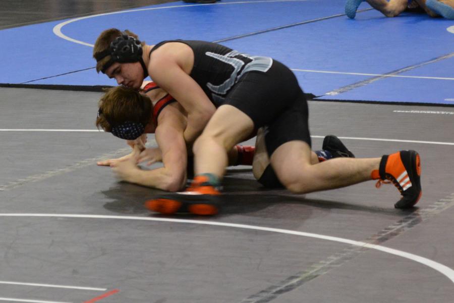 Junior Aaron Peterson wrestles at districts