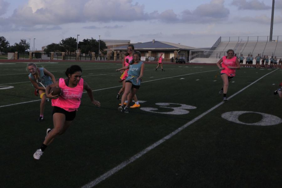 Kristin Guerra makes a first down for the senior team after speeding past Cassidy Cavanaugh 