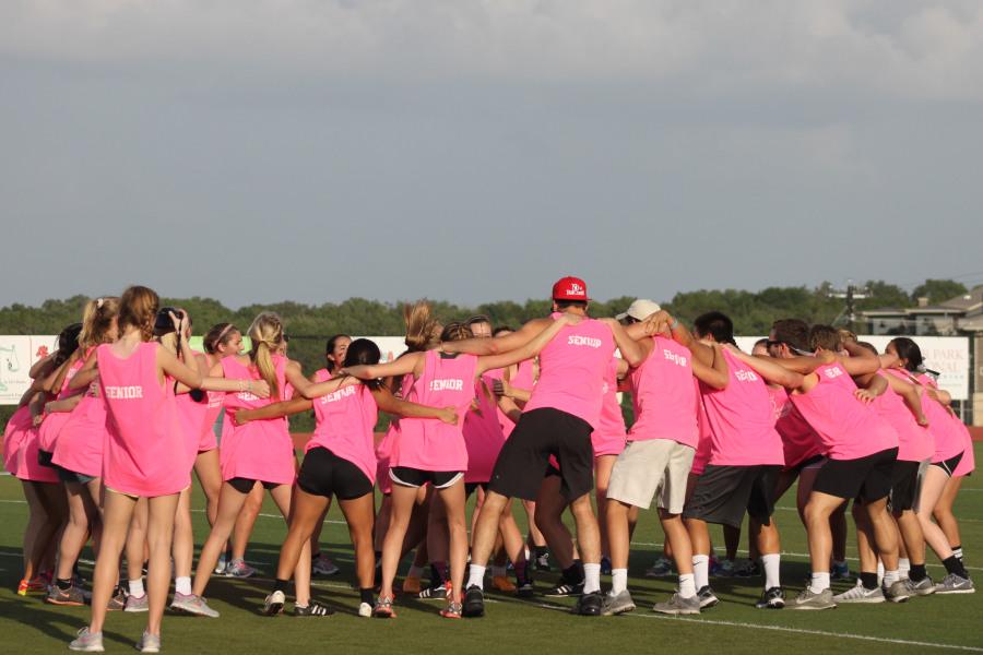 The senior team circles up to do the chant that Coach Hardy does before soccer games. They changed lady vipers to seniors.