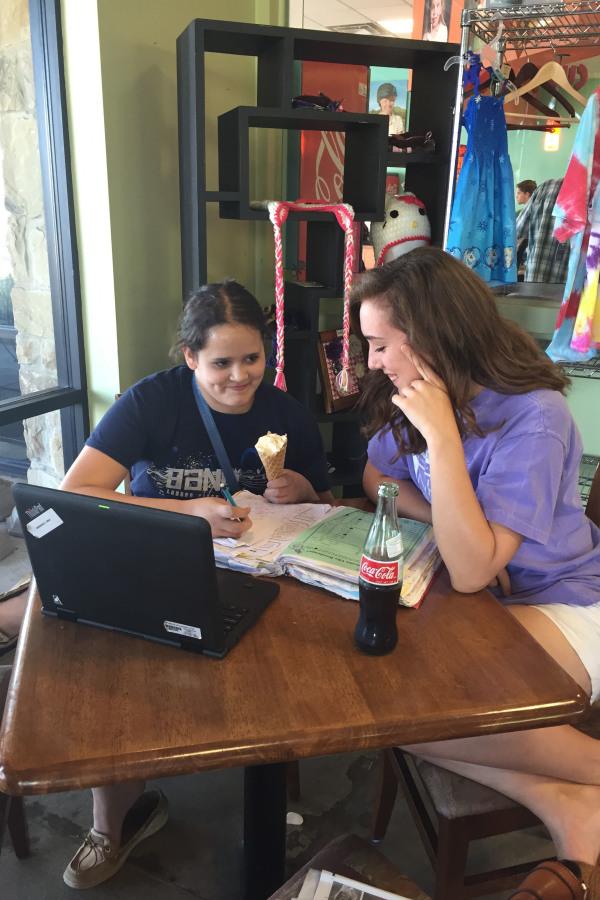 Madeleine LeBoeuf helps a student with her homework