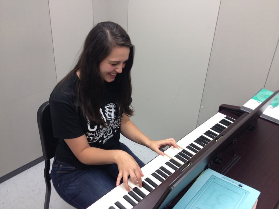 Madison Whitesides practicing her songs on the piano.