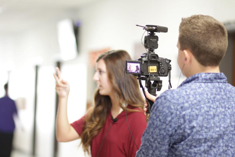 Sophomore broadcast student Jake Painter films senior broadcast student Emma Spasaro while she conducts an interview.