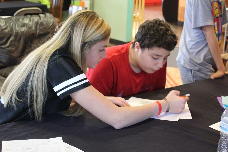 Senior Darby Wright helps a student with a math assignment.