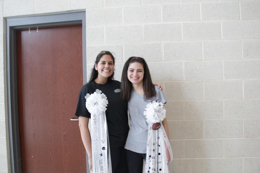 Seniors Ariana Engles and Emma Rose Floyd show off their mums