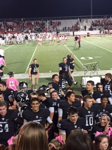 The varsity football team celebrates their 63-55 win against Vista Ridge with the student section.