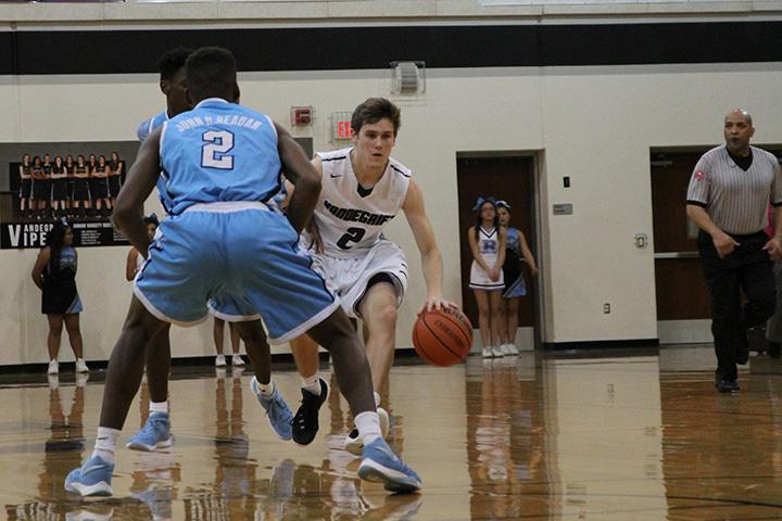 Point guard Drayton Whiteside dribbles the ball down the court against Reagan High School Feb.  23. The Vipers defeated Reagan 69-45.   