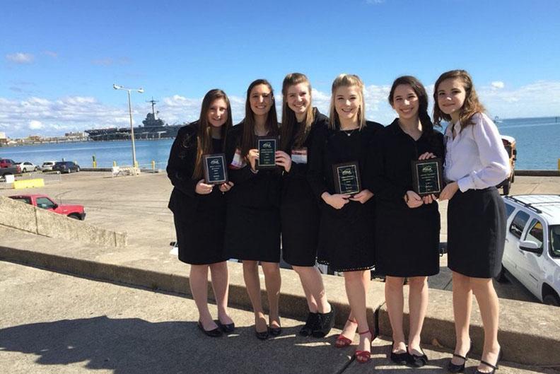 FCCLA Competitors hold up their awards at the district competition in Corpus Christi.