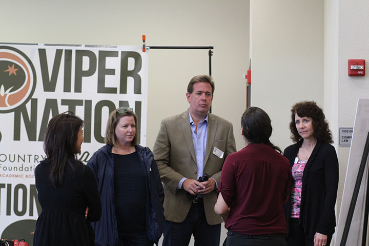 Board members meet with librarian Zandra Lopez to go over library transformations.