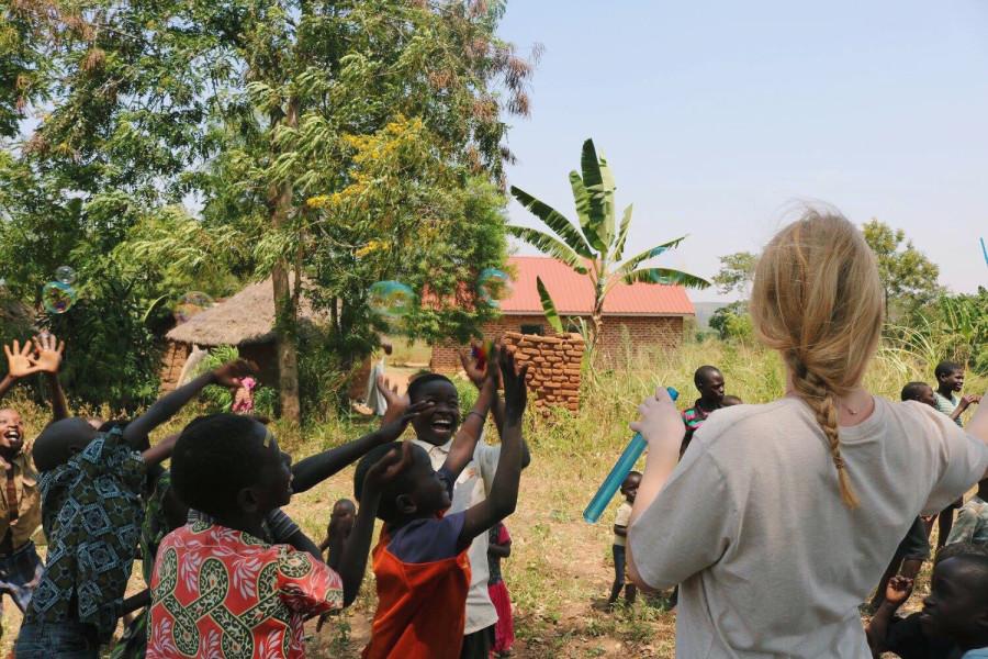 Sophomore Lizzy Hill visits with the locals in Uganda. 