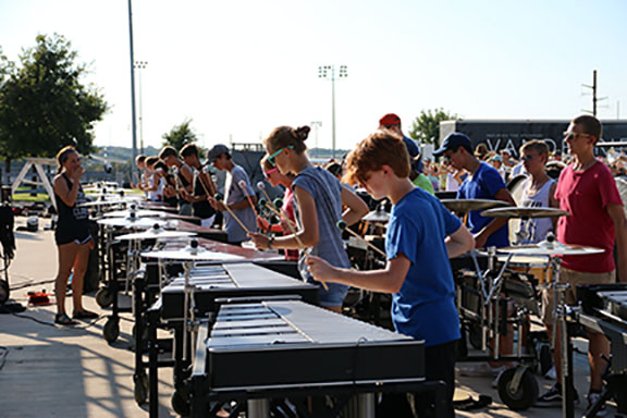 The percussion section practices the marching show.