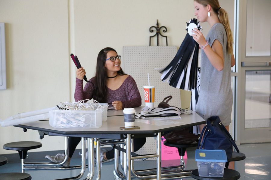 Senior Yamile Morales-Burnet helps at the Legacies mum store. Students could have the Legacies put together their mum for an extra fee.