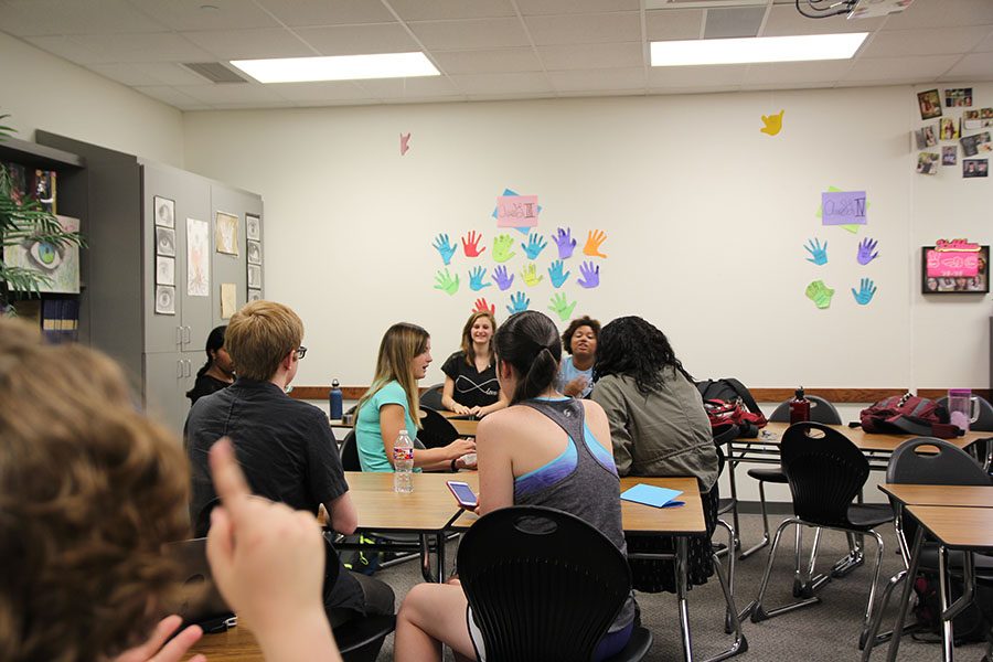 Junior Brianna Mullins signs across the ASL classroom to Junior Samantha Levy.