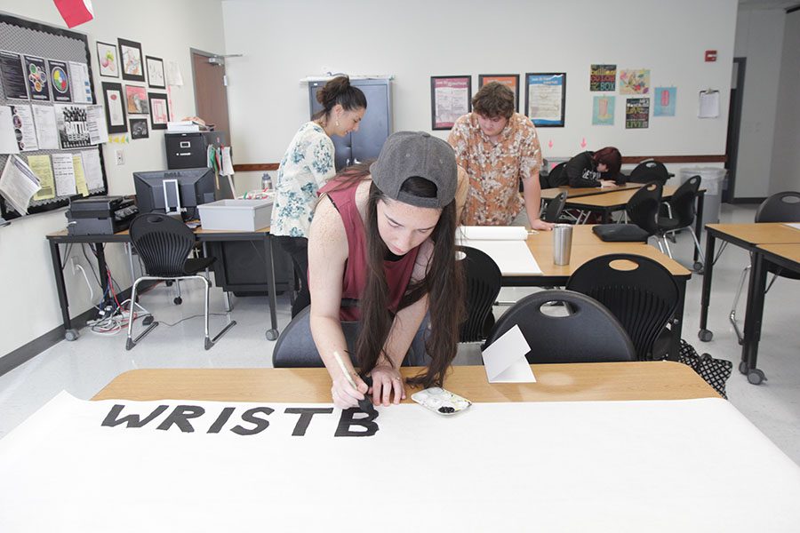 Junior Makayla Mears works on a Mental Health Awareness Week poster in her Mental Health and Counseling class.