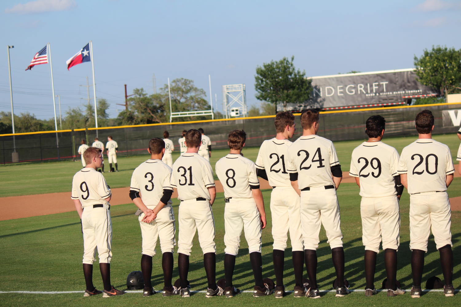 Viper varsity baseball players line up before starting  a game