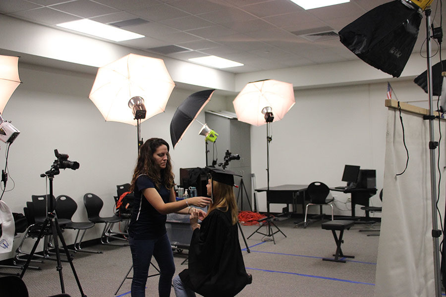 Senior Riley Collister poses for cap and gown senior portrait