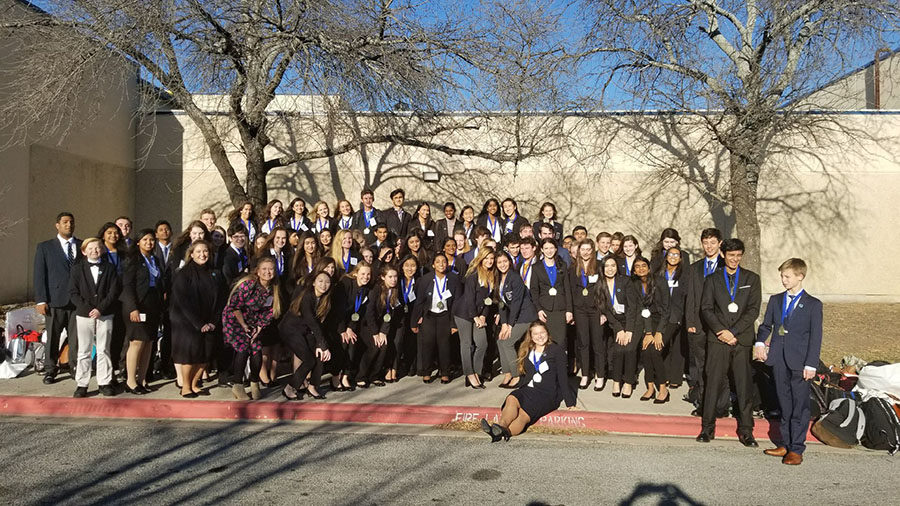 DECA competitors pose for a photo together after district.