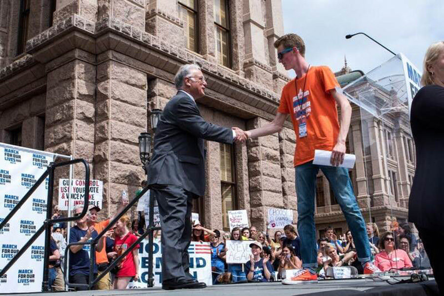 Kyle Legg shakes hands with Lake Travis senator after delivering a speech at the march
