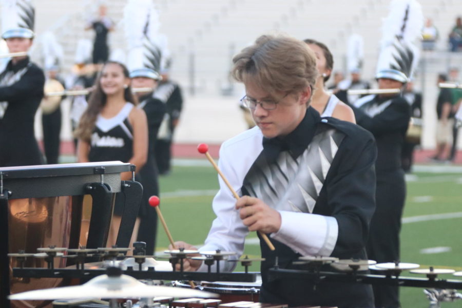 Senior Cameron Brighton plays the xylophone during a pregame performance.    Photo by Nina Castaneda