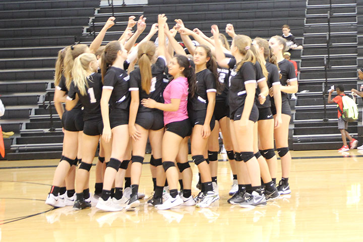 The varsity team huddles before a play during the LISD volleyball tournament.