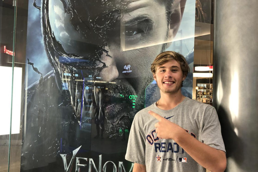 Posing for a picture in front of the movie poster.