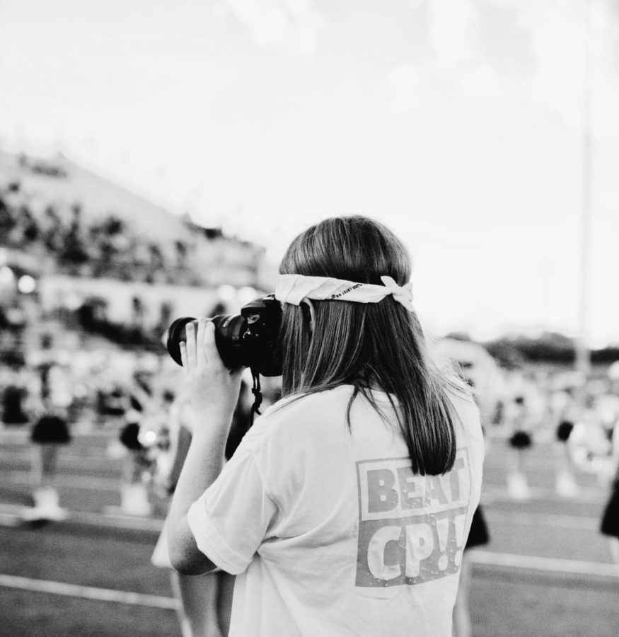 Elaina Eichorn takes pictures during pregame at the Cedar Park football game. 