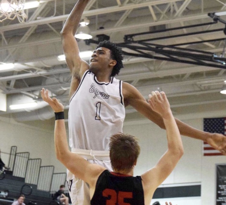 Greg Brown dunks over the defender. 