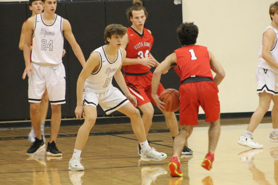 Junior James Parker Oliver defends against an oncoming Vista Ridge player