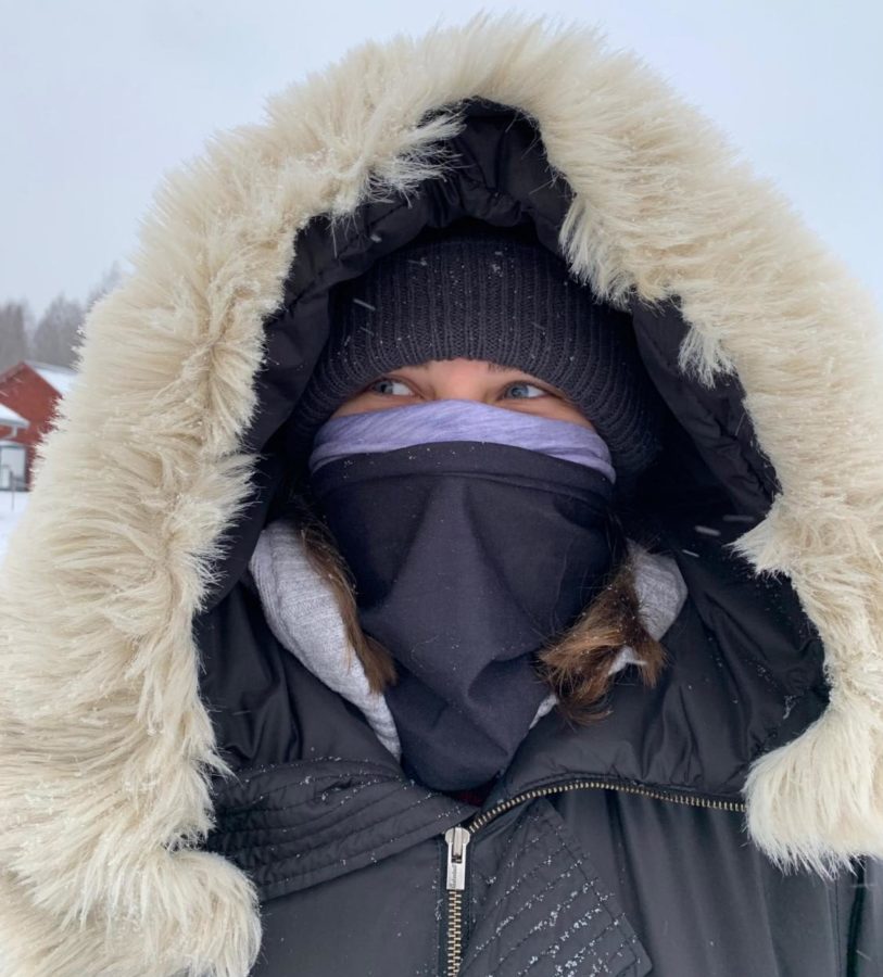 Julia dresses in warm clothing in the snow.