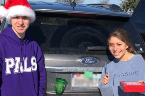 PALS, Allena Gallagher and Zach Chmura leave Candy-Canes with positive notes on students cars.