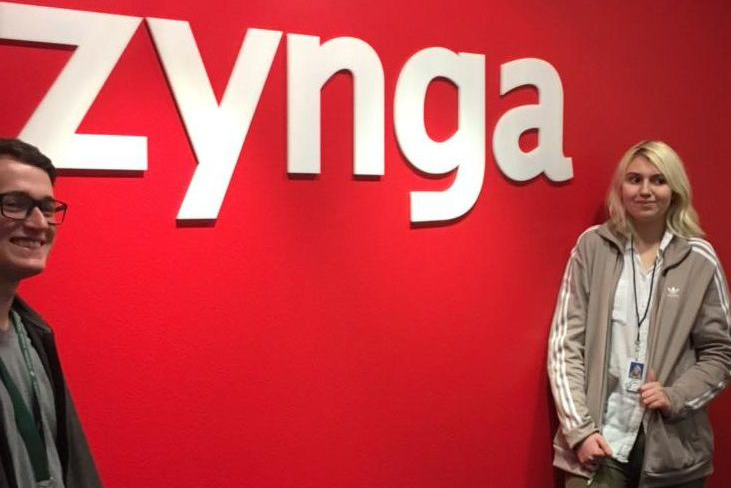 Suerkan (right) poses for a picture in front of a Zynga sign.