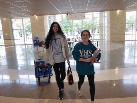 Journalism competitors Harshita Avirneni (left) and Jennifer Walker (right) walk through the school while at another meet.