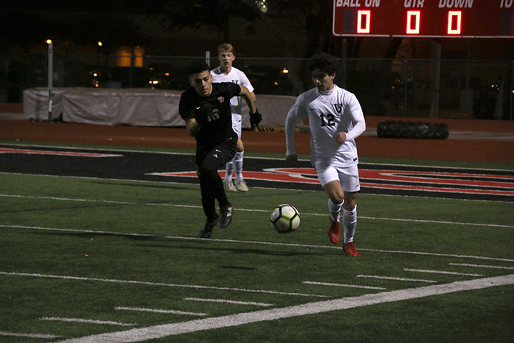 Junior Elliot Keefe takes the ball past a Vista Ridge player