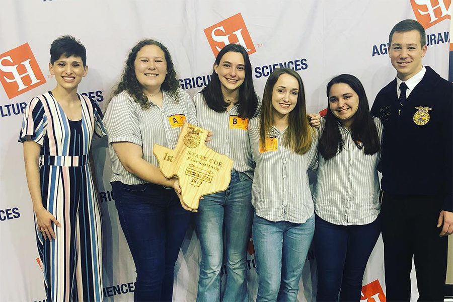 The Floriculture team takes a picture with their plaque.