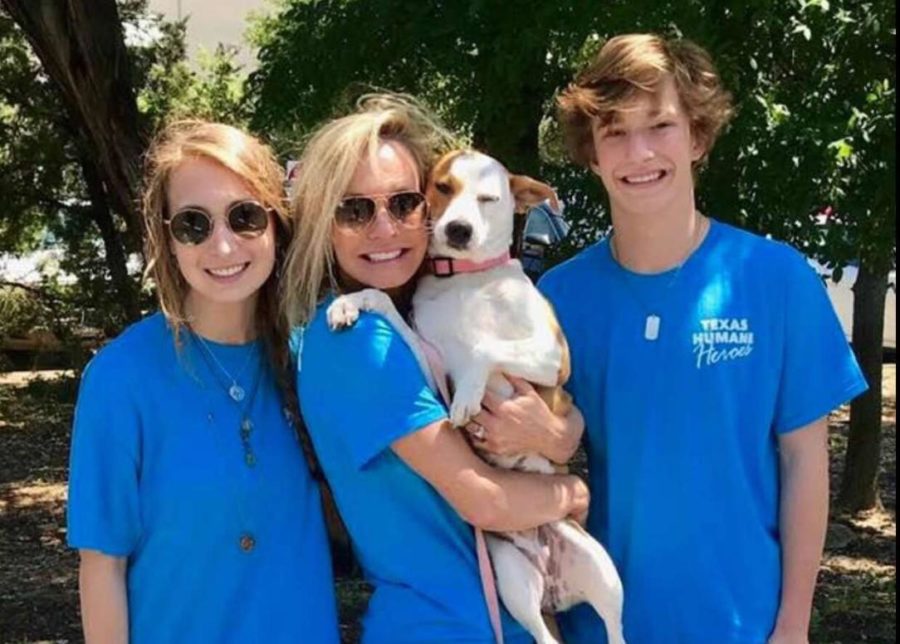 Olivia%2C+Christian%2C+and+their+mother+with+a+dog+up+for+adoption+from+the+Texas+Humane+Heroes+at+an+event.