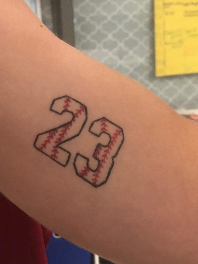 Senior Peyton Klam shows his tattoo of the number 23 on his bicep.